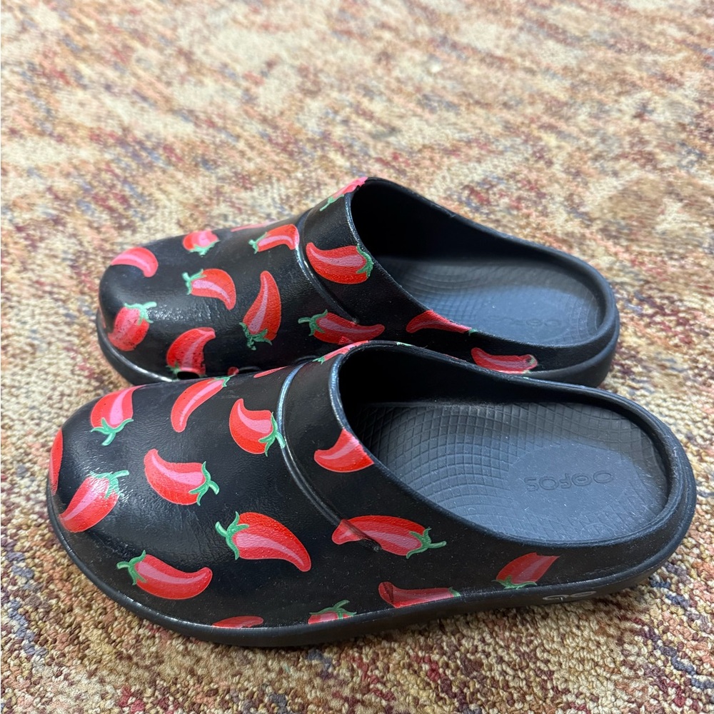Women’s Black Oofos Clogs with Playful Chili Pepper Design